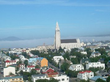 Featured is a photo of the rooftops of Old Town Reykjavik, Iceland; the Hallgrimskirkja Church dominates the skyline.  Amazingly, the approach to the Reykjavik airport falls right over the city proper.  Photo is by "Girdi" and is used courtesy of the GNU Free Documentation 1.2 License. (http://commons.wikimedia.org/wiki/File:Reykjavik_A%C3%B0flug_Braut_19.JPG)